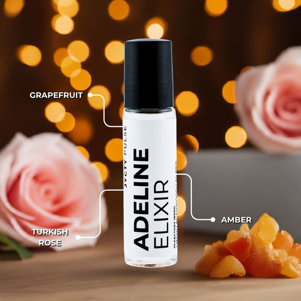 Adeline Elixir bottle with floral and fruit elements on a blurred background