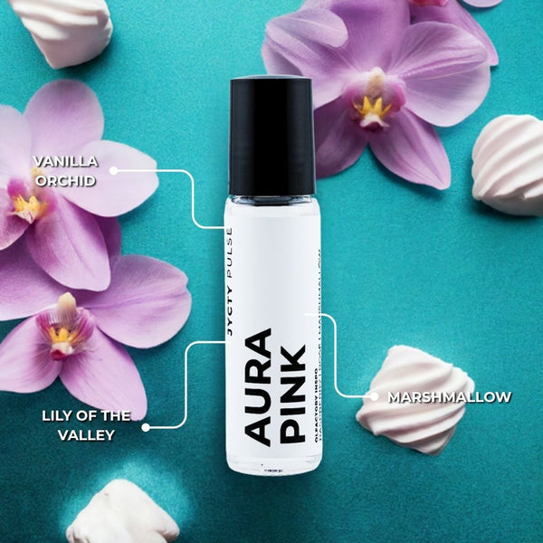 Aura Pink perfume bottle with floral and marshmallow elements on a teal background