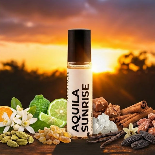 Roll-on bottle labeled 'Aquila Sunrise' with natural ingredients on a wooden surface against a sunset background.