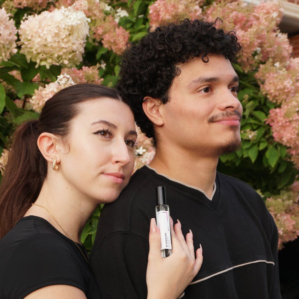 Two people standing together with a floral background JYCTY Toronto Collection