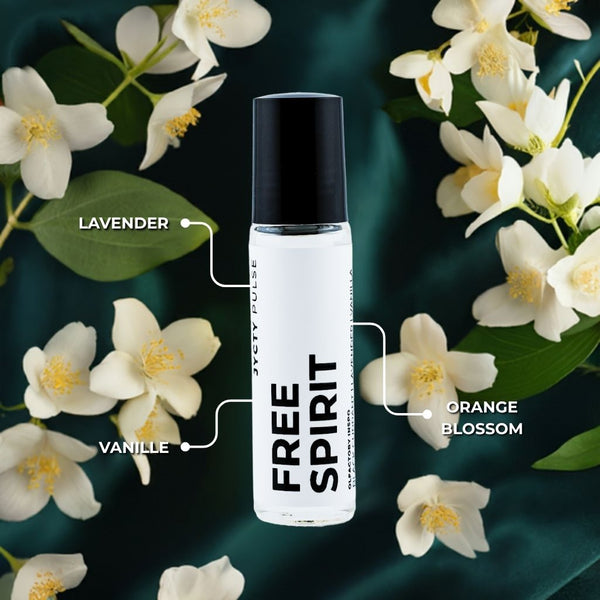 Free Spirit perfume bottle surrounded by white flowers on a dark green background