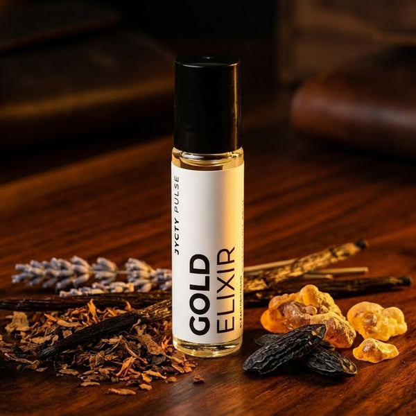 Bottle of Gold Elixir cologne oil on a wooden surface with dried herbs and spices.