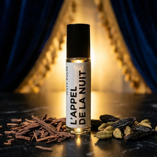 Perfume bottle labeled 'L'Appel de la Nuit' on a dark surface with decorative elements.