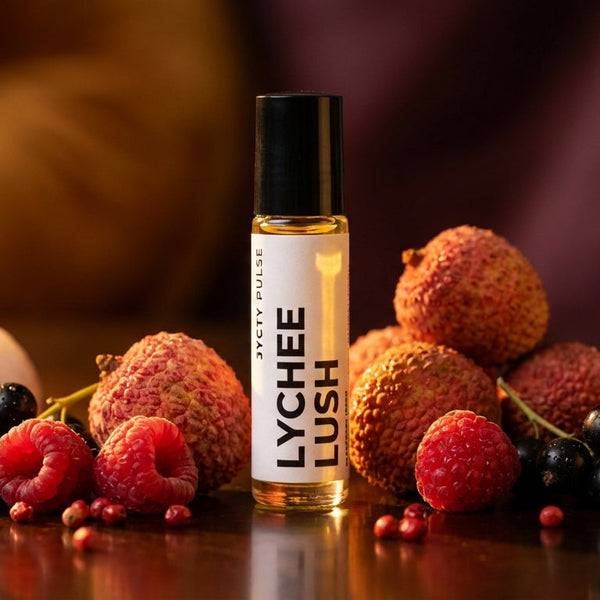Lychee Lush product bottle surrounded by lychees and other fruits on a wooden surface.