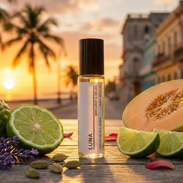 LUNA perfume oil product with tropical fruits and plants on a wooden table at sunset. amazing smell and long lasting oil by JYCTY