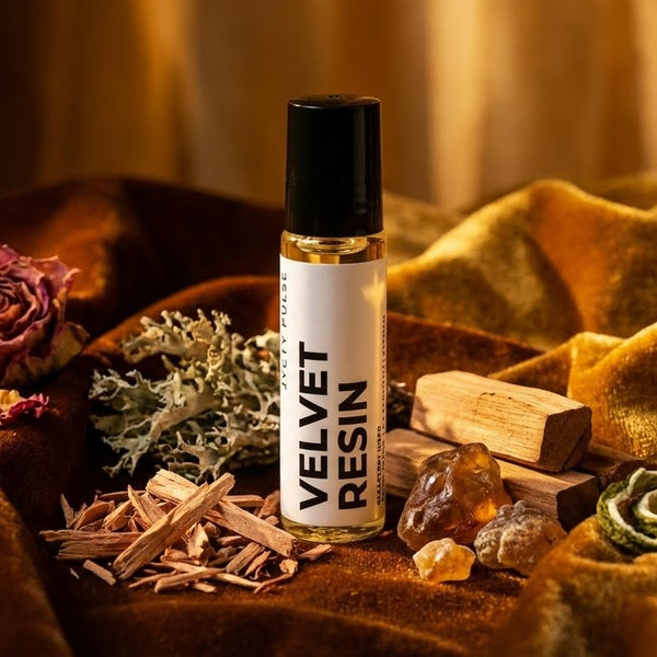 Bottle of 'Velvet Resin' with decorative elements on a textured surface. Long lasting perfume oil. Vegan and cruelty free